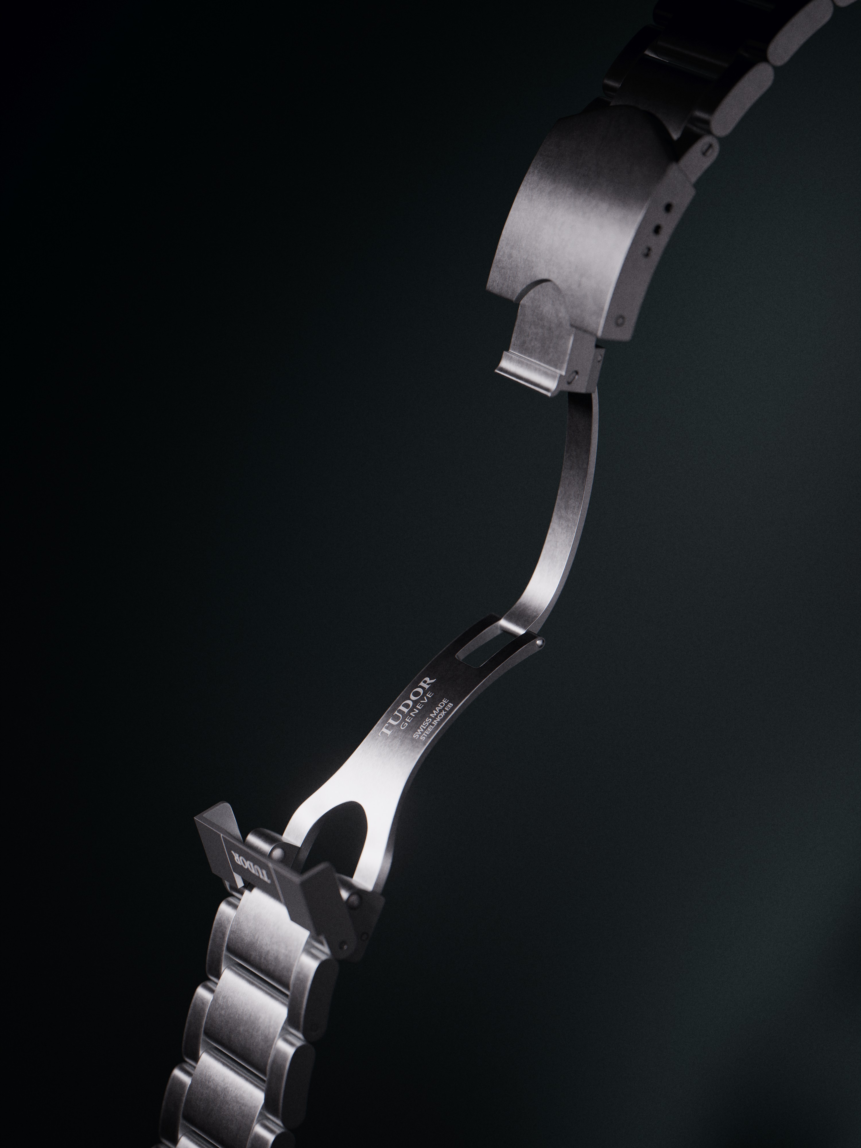 Tudor Heritage Ranger steel bracelet displaying brushed finish links and signed folding clasp. The three-link design features polished center links contrasting with brushed outer links. The bracelet architecture demonstrates the robust engineering and attention to detail characteristic of Tudor timepieces. Professional studio lighting emphasizes the interplay of different surface finishes.