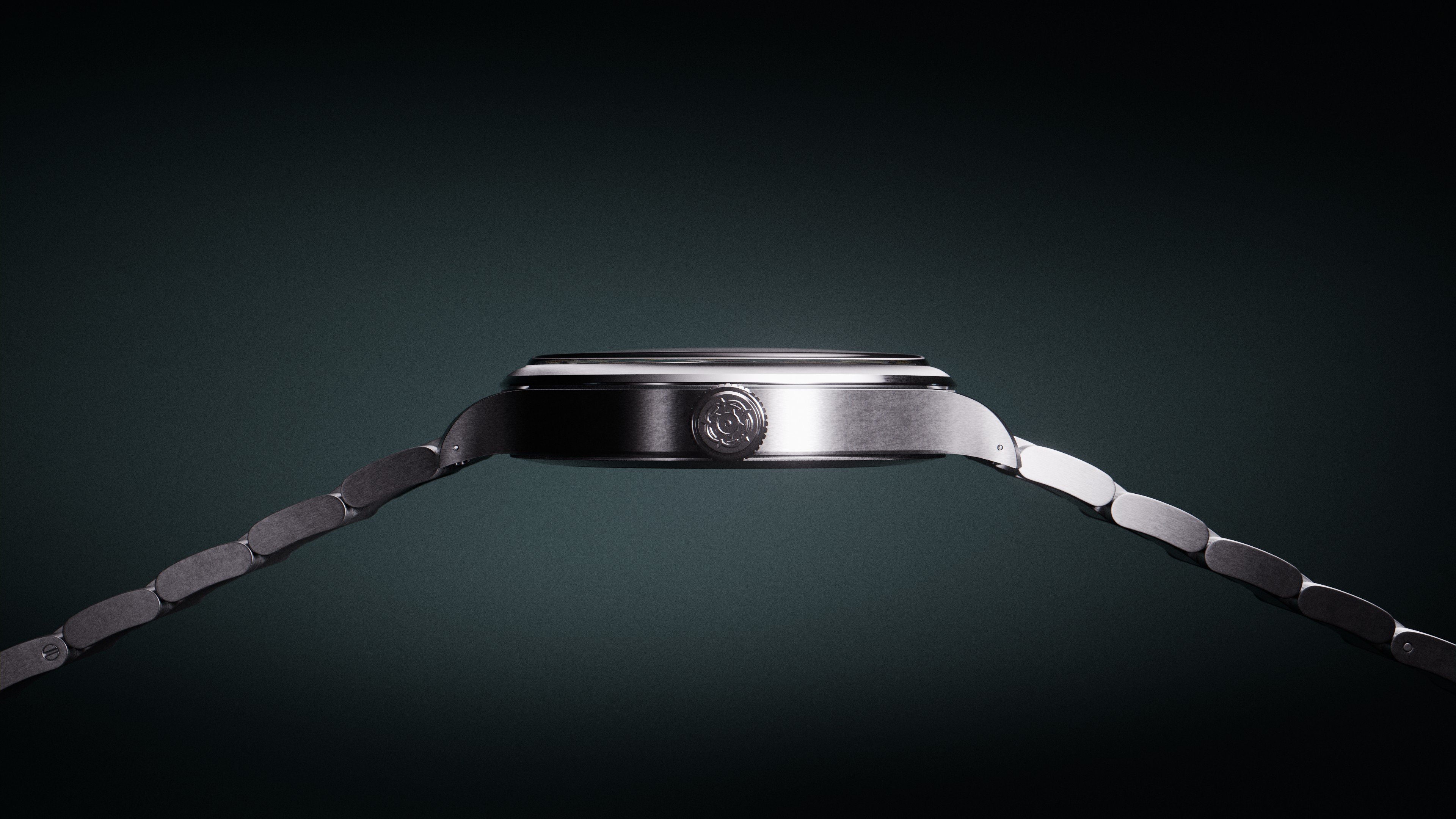 Side profile of Tudor Heritage Ranger watch displaying its sleek case architecture. The crown is prominently visible against the brushed steel case, showing the precise engineering and smooth transitions between surfaces. Professional studio lighting emphasizes the vertical brushing on the case sides.